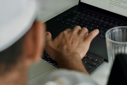 Hands on a keyboard at a desk, staff augmentation model guide