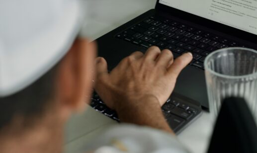 Hands on a keyboard at a desk, staff augmentation model guide